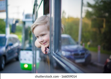 Adorable Girl Ride By Bus And Look Through Open Window. Outside Shoot