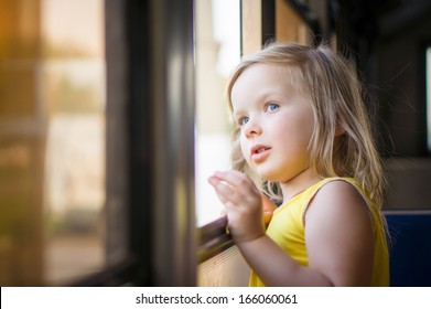 Adorable Girl Ride By Bus And Look Through Open Window Outside