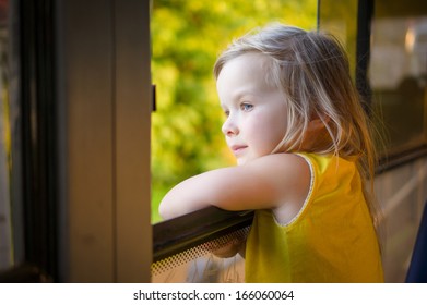 Adorable Girl Ride By Bus And Look Through Open Window Outside