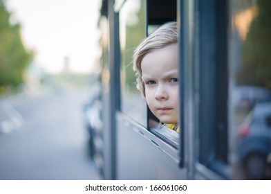 Adorable Girl Ride By Bus And Look Through Open Window. Outside Shoot