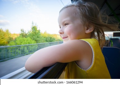 Adorable Girl Ride By Bus And Look Through Open Window Outside