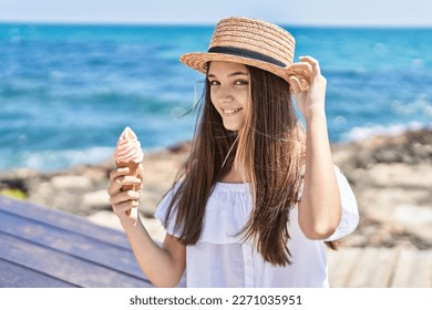 Adorable girl tourist smiling confident eating ice cream at seaside - Powered by Shutterstock