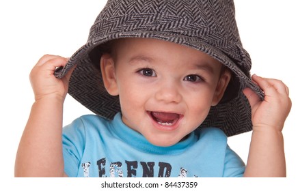 An Adorable Hispanic Baby Is Holding A Hat.  Image Is Isolated On White With Reflection.