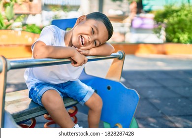 Adorable Hispanic Boy Smiling Happy Playing At The Park.