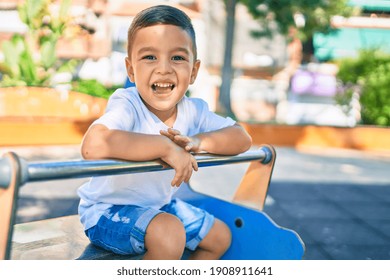 Adorable hispanic boy smiling happy playing at the park. - Powered by Shutterstock