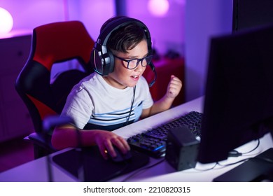 Adorable hispanic boy streamer playing video game with winner expression at gaming room - Shutterstock ID 2210820315