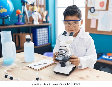 Adorable hispanic boy student smiling confident using microscope at laboratory classroom - Powered by Shutterstock - Get 15% off with code: PIKWIZARD15
