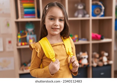 Adorable hispanic girl student smiling confident standing at kindergarten - Powered by Shutterstock