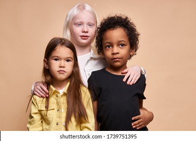 Adorable Kids Of Diverse Nationalities And Skin Colors Stand Together Posing At Camera, Group Of Beautiful Children, Albino Girl Hug Friends. Albinism, People Diversity, Children Concept