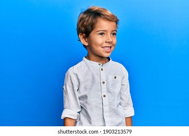 Adorable Latin Kid Wearing Casual Clothes Looking To Side, Relax Profile Pose With Natural Face And Confident Smile. 