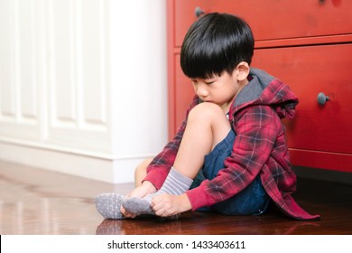 An Adorable Little Asian Boy Putting On Socks, Getting Ready For School. Montessori Practical Life Skills, Self-care, Child Development, Fine Motor, Hand Eye Coordination, Kids Daily Routine Concept.