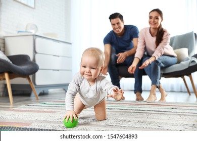 Adorable little baby crawling near parents at home - Powered by Shutterstock