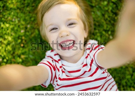 Similar – Small child with long blond hair