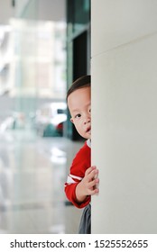 Adorable Little Boy Hide Behind A Corner Room. Baby Playing Peekaboo Game Indoor.