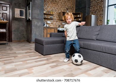 Adorable Little Boy Playing With Soccer Ball At Home