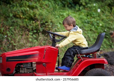 Adorable Little Boy, Pretending To Ride A Lawn Mower, Making Funny Faces