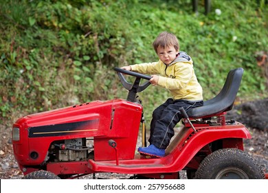 Adorable Little Boy, Pretending To Ride A Lawn Mower, Making Funny Faces