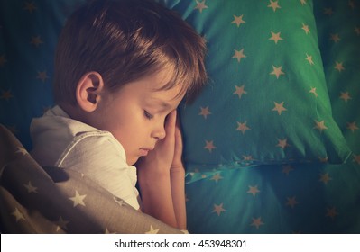 Adorable Little Boy Sleeping In Bed