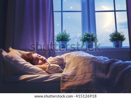 Adorable little child girl sleeping in the bed. Quiet sleep quiet starry night.