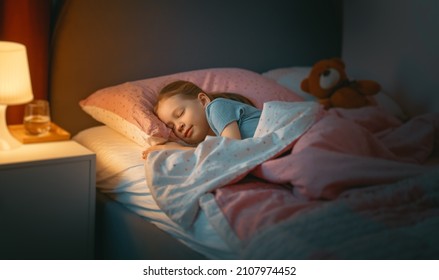 Adorable little child is sleeping in the bed. - Powered by Shutterstock