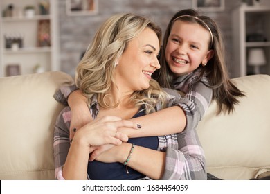 Adorable Little Girl With Braces Having A Big Smile While Hugging Her Mother.