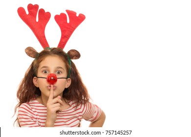 Adorable Little Girl Dressed As Rudolph The Reindeer Shushing To The Camera Isolated Copyspace Antlers Nose Costume Children Kids Quiet Secret X-mas Presents Merry New Year Holidays Family