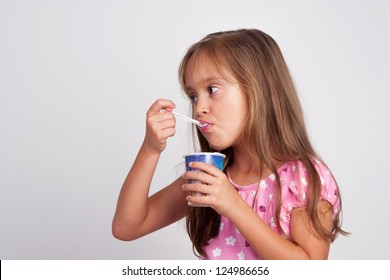 Adorable Little Girl Eating Yogurt