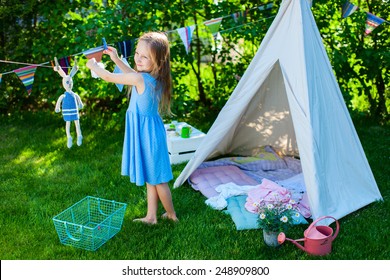 Adorable little girl having fun playing outdoors on summer day