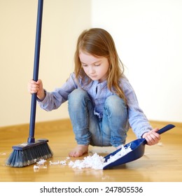 Adorable Little Girl Helping Her Mom To Clean Up At Home