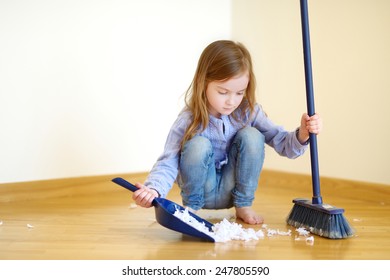 Adorable Little Girl Helping Her Mom To Clean Up At Home