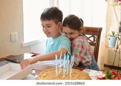 Adorable little girl hugging her older brother while unpacking a gift box with happy surprise inside it, celebrating happy birthday event at home. People. Lifestyle. Family relationships - Shutterstock ID 2311628863
