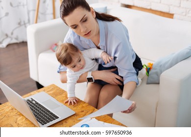 Adorable little girl looking interested in moms business