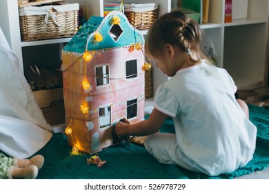 Adorable Little Girl Playing With A Hand Made Card Box Doll House