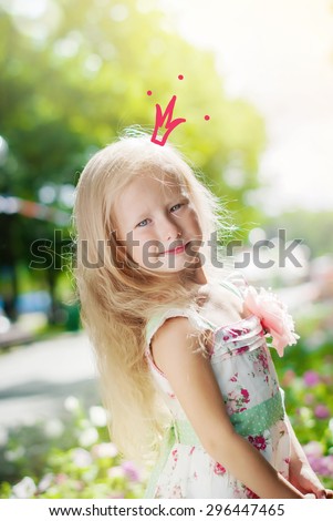 Adorable Little Girl Posing as Princess with Drawn Crown in Morning Park