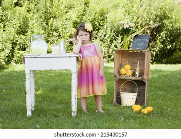 Adorable Little Girl Pouting That She Has No Customers At Her Lemonade Stand.  