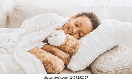 Adorable little girl sleeping in bed with toy, hugging the teddy bear, empty space - Powered by Shutterstock