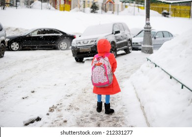 Adorable Little Girl Walking From School On Winter Day In The City