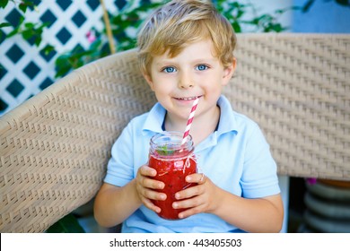 Adorable Little Kid Boy Drinking Healthy Fruits And Vegetables Juice Smoothie In Summer. Happy Child Enjoying Organic Drink.