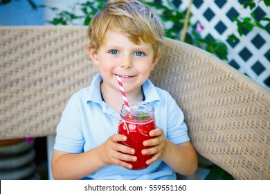 Adorable Little Kid Boy Drinking Healthy Fruits And Vegetables Juice Smoothie In Summer. Happy Child Enjoying Organic Drink. Blond Toddler Tasting Berries, Fruits And Vegetables Juice.