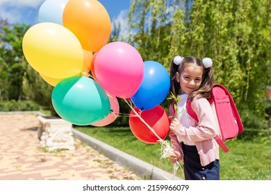 Adorable Little Kid Girl With Backpack On His First Day To School Or Nursery. Child Outdoors On Warm Sunny Day, Back To School Concept.