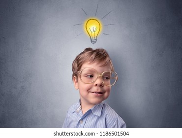 Adorable little kid mull over in front of a grey wall with idea symbol above his head - Shutterstock ID 1186501504