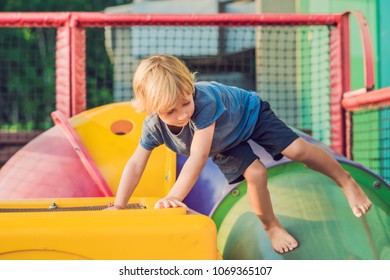 Adorable little toddler boy having fun on playground - Shutterstock ID 1069365107