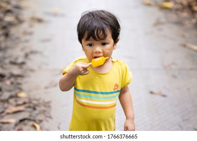 Adorable Malay Boy Eating An Ice Cream