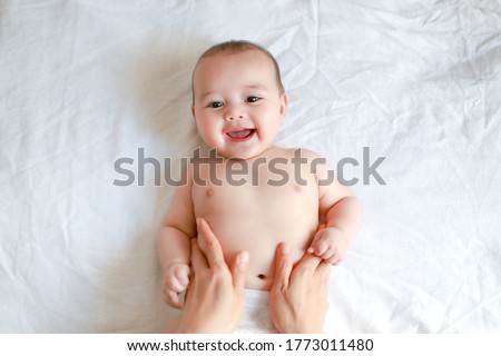 Similar – Image, Stock Photo Baby lying on his back as his doctor examines him during a standard medical checkup
