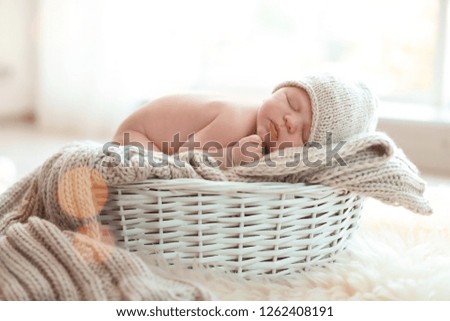 Similar – Baby lying in a wicker basket