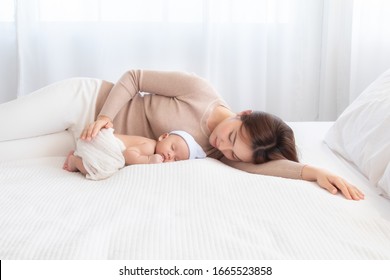 Adorable Newborn Baby Sleeping On Bed In Mother Arm Nursing, Young Asian Beautiful Mother Lying Down Hold Hug  Infant 0-1 Month With Love, Gently, Happy Sleeping Trust Safe Caring Lovely Motherhood