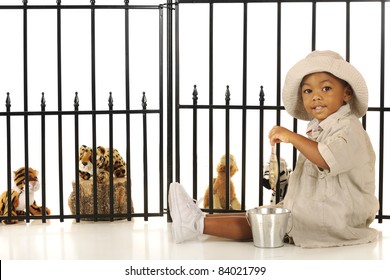 An Adorable Preschool Zookeeper Feeding Fish To The Critters In His Pretend Zoo.