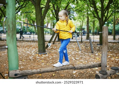 Adorable preschooler girl on playground on a sunny autumn day. Preschooler child playing outdoors. Outdoor activities for kids. - Powered by Shutterstock