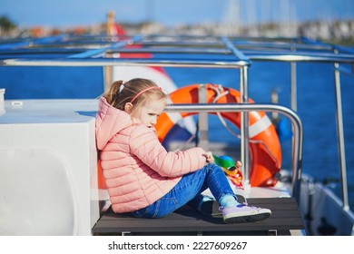Adorable preschooler girl sitting on the deck of ferry boat travelling from Marken to Volendam, North Holland, the Netherlands - Shutterstock ID 2227609267