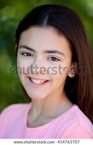 Adorable preteen girl with plants of background